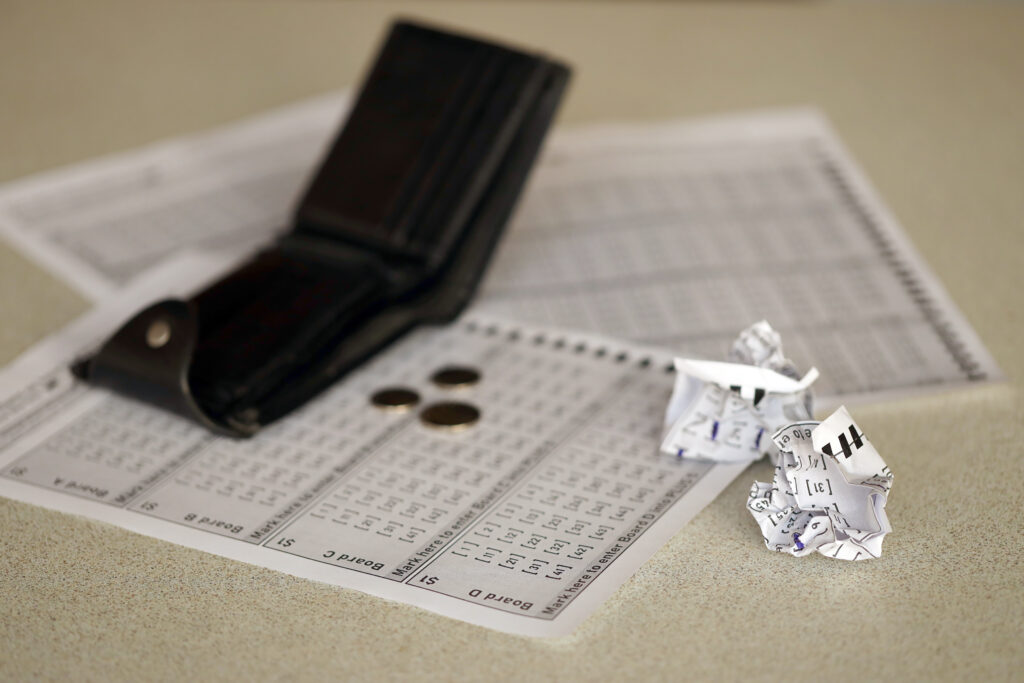 Crumpled Lottery Tickets And Empty Purse As Symbol Of Losing The Lottery Game. Unlucky Gambling Results. Misfortune