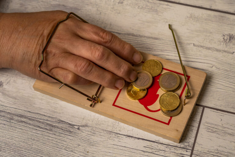 Hand Caught In A Mousetrap While Picking Up Money